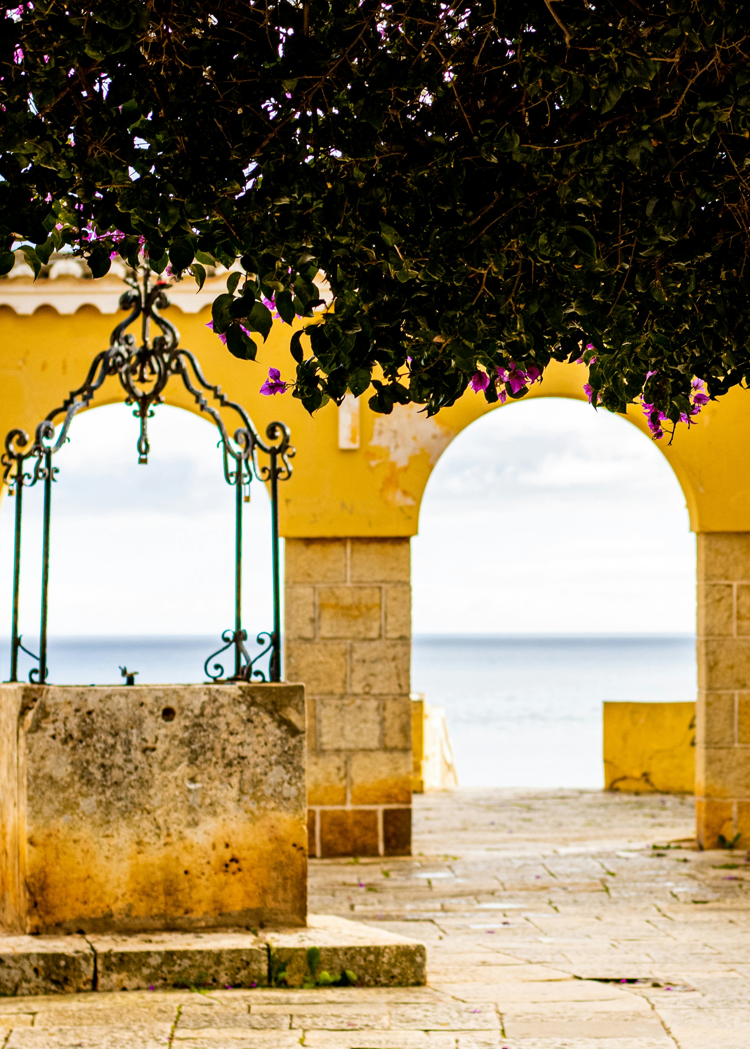 Portuguese archway in Portimão with bougainvillea